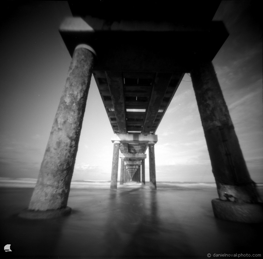 Through the Pier, Duck, NC. Pinhole Photography from OBX 2025. terraPIN ACME pinhole camera, Kodak T-Max 100 black and white negative film, D-23 developer.
