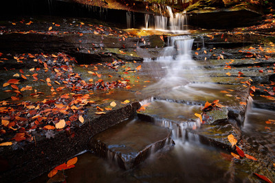 Colorful leaves falling water of Lower Emery Falls of Emery County Park in the Fall - Autumn. East Aurora, Buffalo, New York (NY).