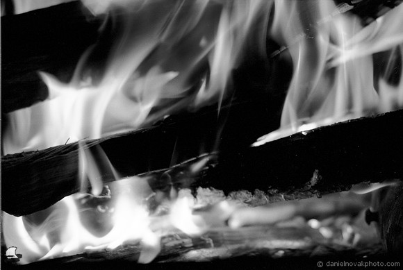 Keeping Warm by a fireplace in Western New York Winter. Photographed with a vintage 35mm Nikon FE2 camera on Fuji Acros 100 black and white negative film, developed in D-23 developer.