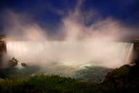 The Horseshoe Falls in White and Blue, Niagara Falls. Mist rising over the illuminated waterfall at dusk during blue hour.
