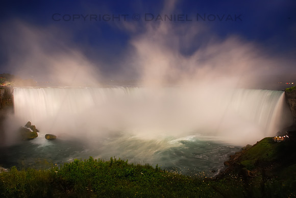 The Horseshoe Falls in White and Blue, Niagara Falls. Mist rising over the illuminated waterfall at dusk during blue hour.