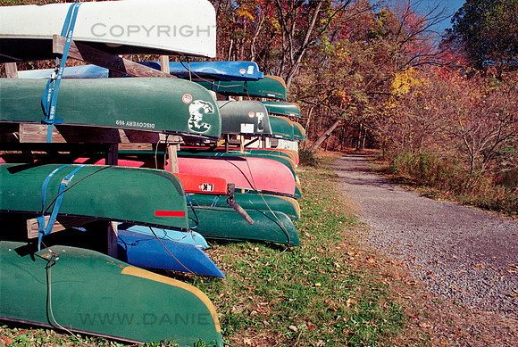 Canoes by Trail, Beebe Lake, Ithaca, NY. Photographed with a vintage 35mm Minolta Maxxum 5 camera on Kodak Colorplus 200 color negative film. Developed in C-41.