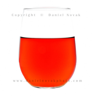 Take notes on lighting setup. Glass of amber tea with uniform color on white background.