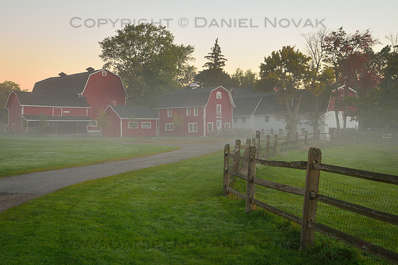A fence-lined path to misty red barns, Knox Farm, East Aurora, NY