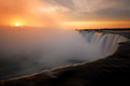 Sunrise over the rising mist of Horseshoe Falls, Niagara Falls, Canada looking back into the United States (USA).
