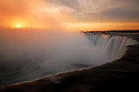 Sunrise over the rising mist of Horseshoe Falls, Niagara Falls, Canada looking back into the United States (USA).