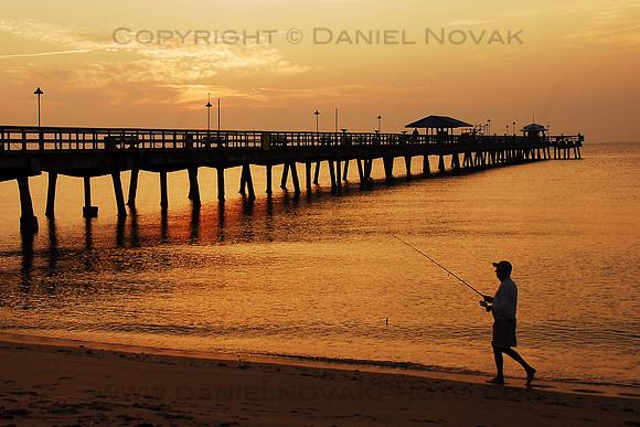 A silhouette of a  Fisherman at Sunrise by a Southern Florida (FL) Pier.