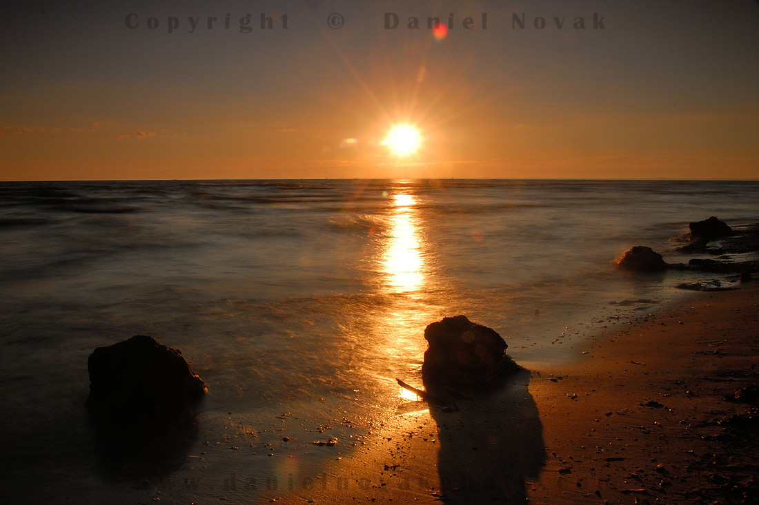 A beautiful sunset, a beautiful end of day in Woodlawn Beach State  Park contrasting the dead fish and shit and feces laying all around.