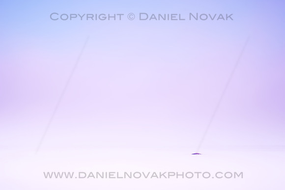 A minimalist take on a foggy morning over Lake Erie showing a single rock wrapped in fog under blue sky. Eighteen Mile Creek mouth, New York (NY)