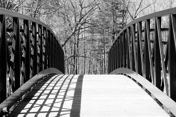 Shadows on the Fishing Pier, Green Lake, Yates Park, Orchard Park, NY. An old-fashioned black and white analog photograph captured with a 35mm Pentax Spotmatic camera on Kodak T-Max 100 negative film.